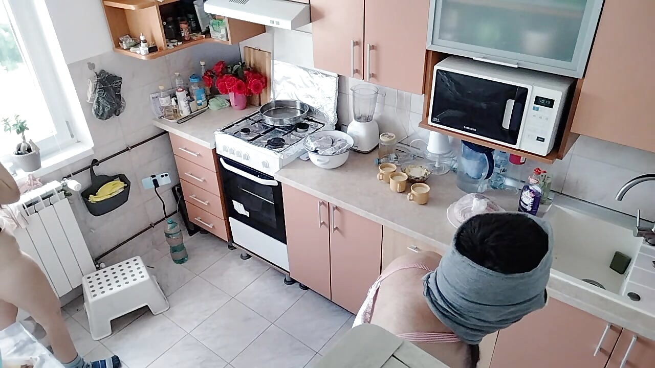 An amateur couple is having fun in the kitchen.