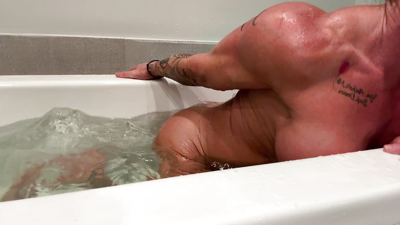 Muscle Goddess Fucks Her Big Clit with the Shower Nozzle