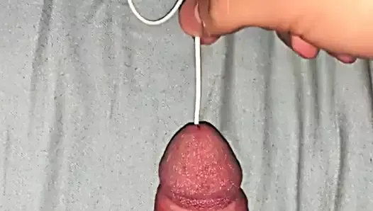 boy insert long cord in bladder