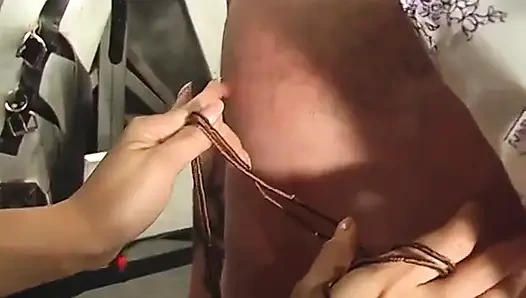 BDSM mistress in thigh-highs ropes dude's collared face and pulls his bound cock
