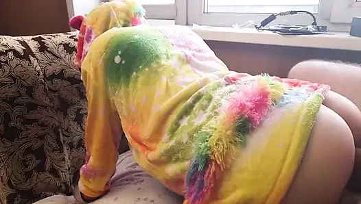 A baby in a unicorn costume shows off her ass
