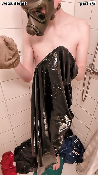 Latex laundry in shower wearing rubber gas mask