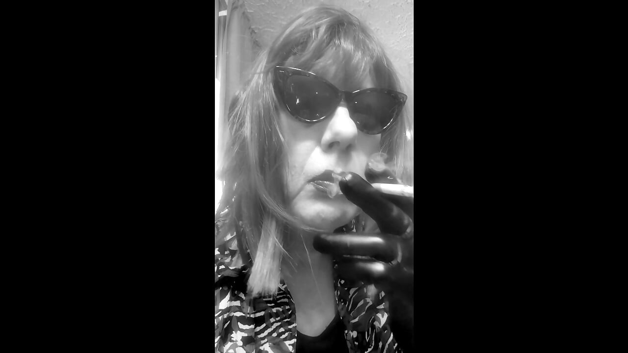 MRS. ROMAN DESTROYING A MARLBORO 100 MENTHOL CLOSE UP - WITH DANGLING AND NOSTRIL EXHALES