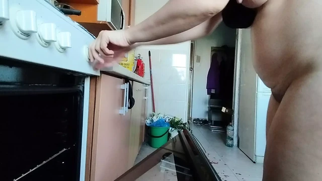 Sexy wife having fun in the kitchen with roses.
