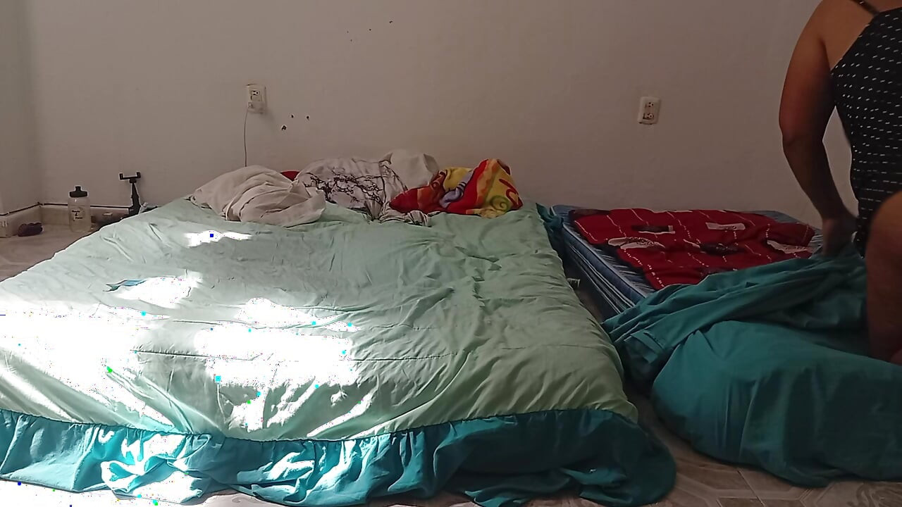Mexican mother-in-law cleaning guest room in thong