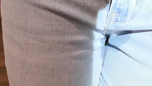 Desperately trying to hold but letting it all out in female light wash jeans