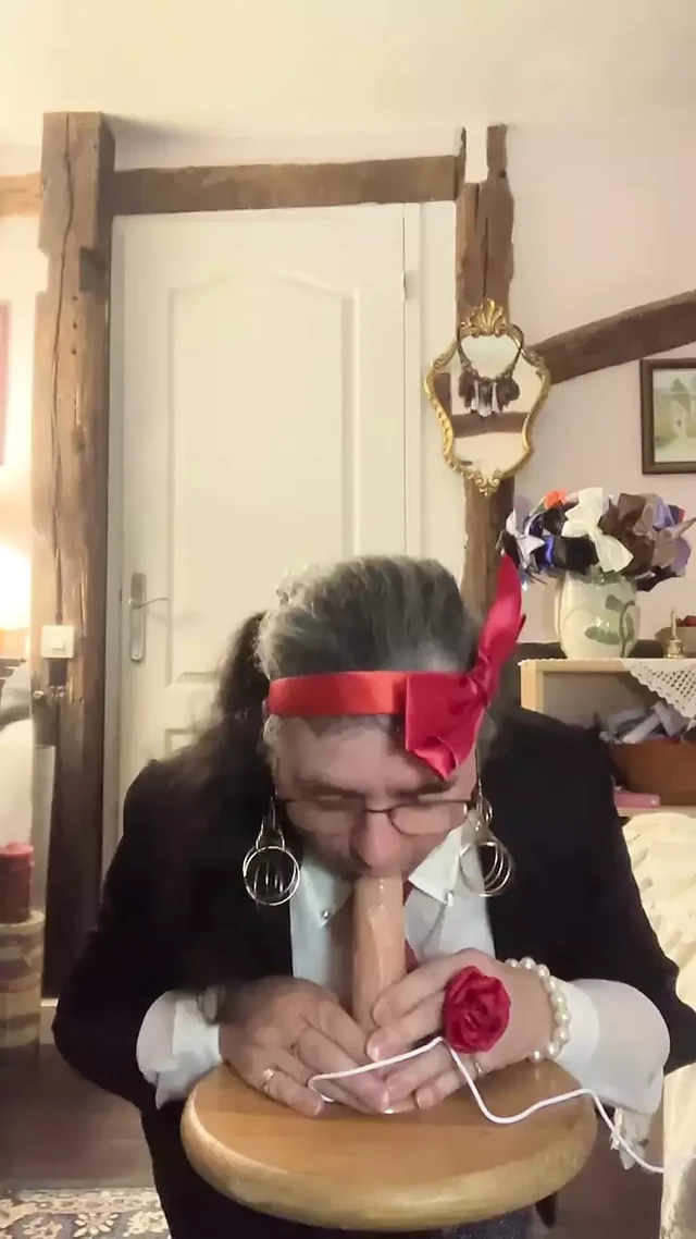 In outfit with a gray evening skirt to suck a dildo