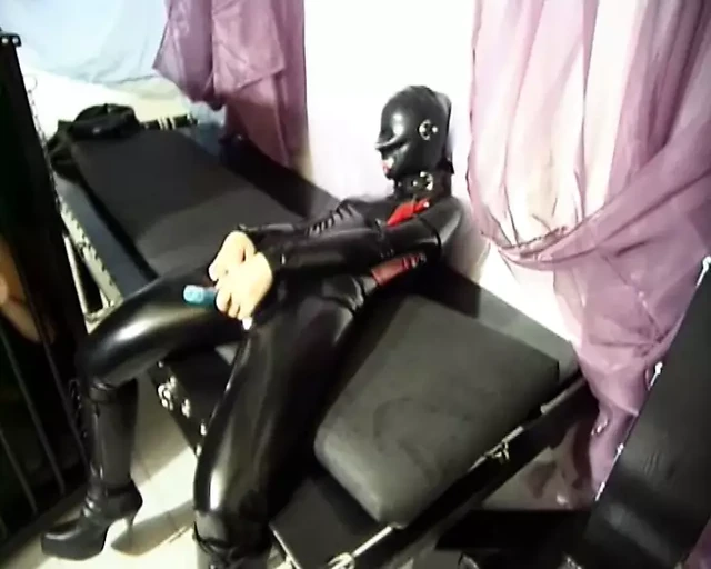 Latex trio submissively fucks each other in the cunt with their rubber dildos