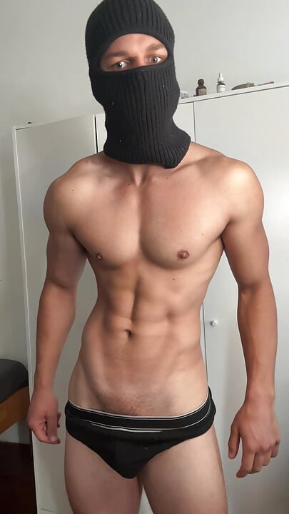 Masked young hunk showing off his muscles