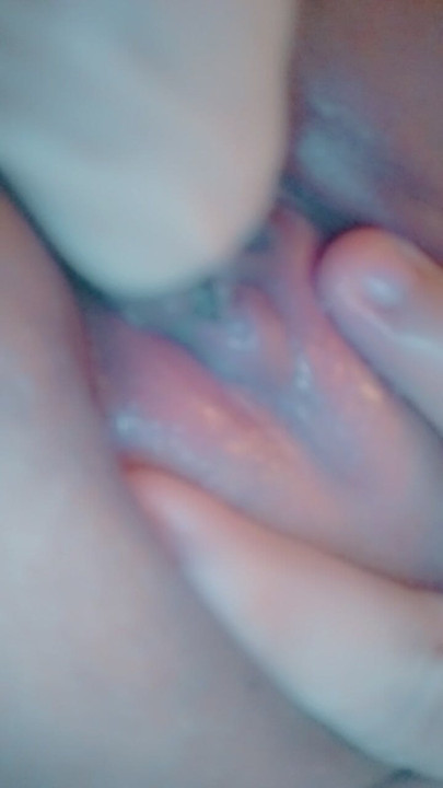 caressing my clitoris with a dildo