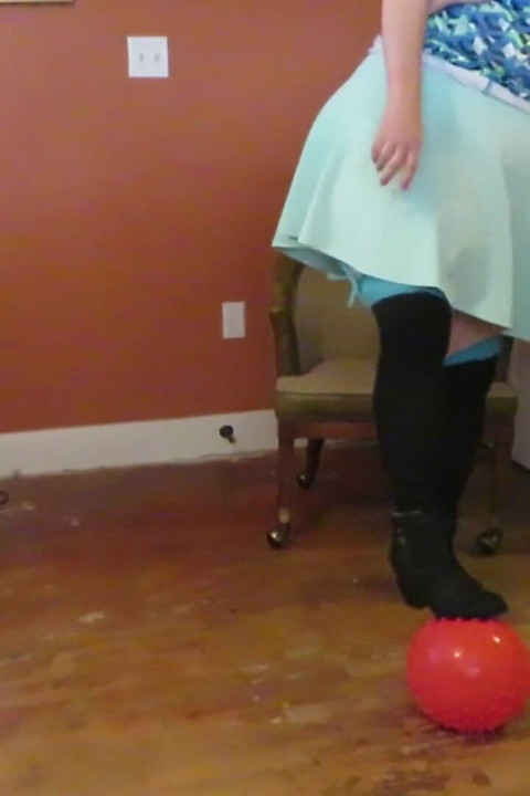 Nurse Vicki  plays with a rubber ball in a mini skirt, sexy stockings and high heel mini boots