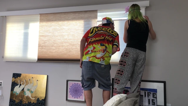 Couple Peeping Outside Apartment Window