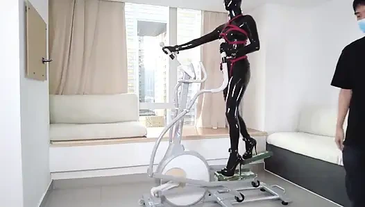 Mz27 - a Girl Bound in Latex Walks on a Treadmill