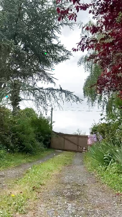 Kledd i et rosa hushjelpantrekk for å hente en pakke fra postkassen
