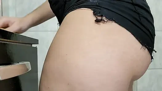 A hot girl in micro shorts cleaning the house.