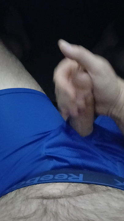 Jerking in dark blue Reebok boxerbriefs