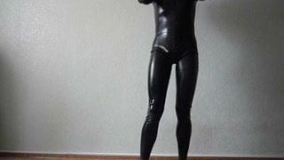 young man in latex catsuit caresses himself