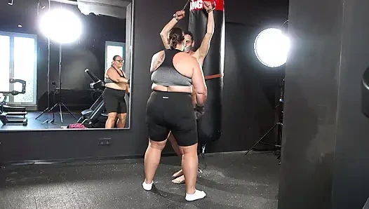 Mistress April practices boxing on a human punching bag.