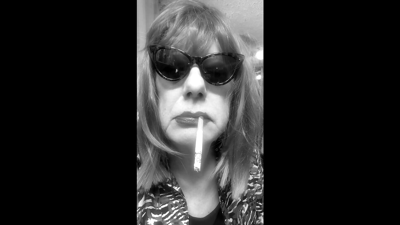 MRS. ROMAN DESTROYING A MARLBORO 100 MENTHOL CLOSE UP - WITH DANGLING AND NOSTRIL EXHALES