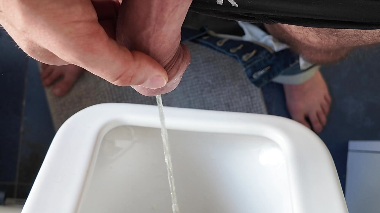 Pissing in the urinal - closeup of big uncut dick