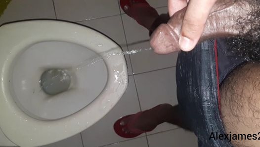 Horny guy pissing in the toilet