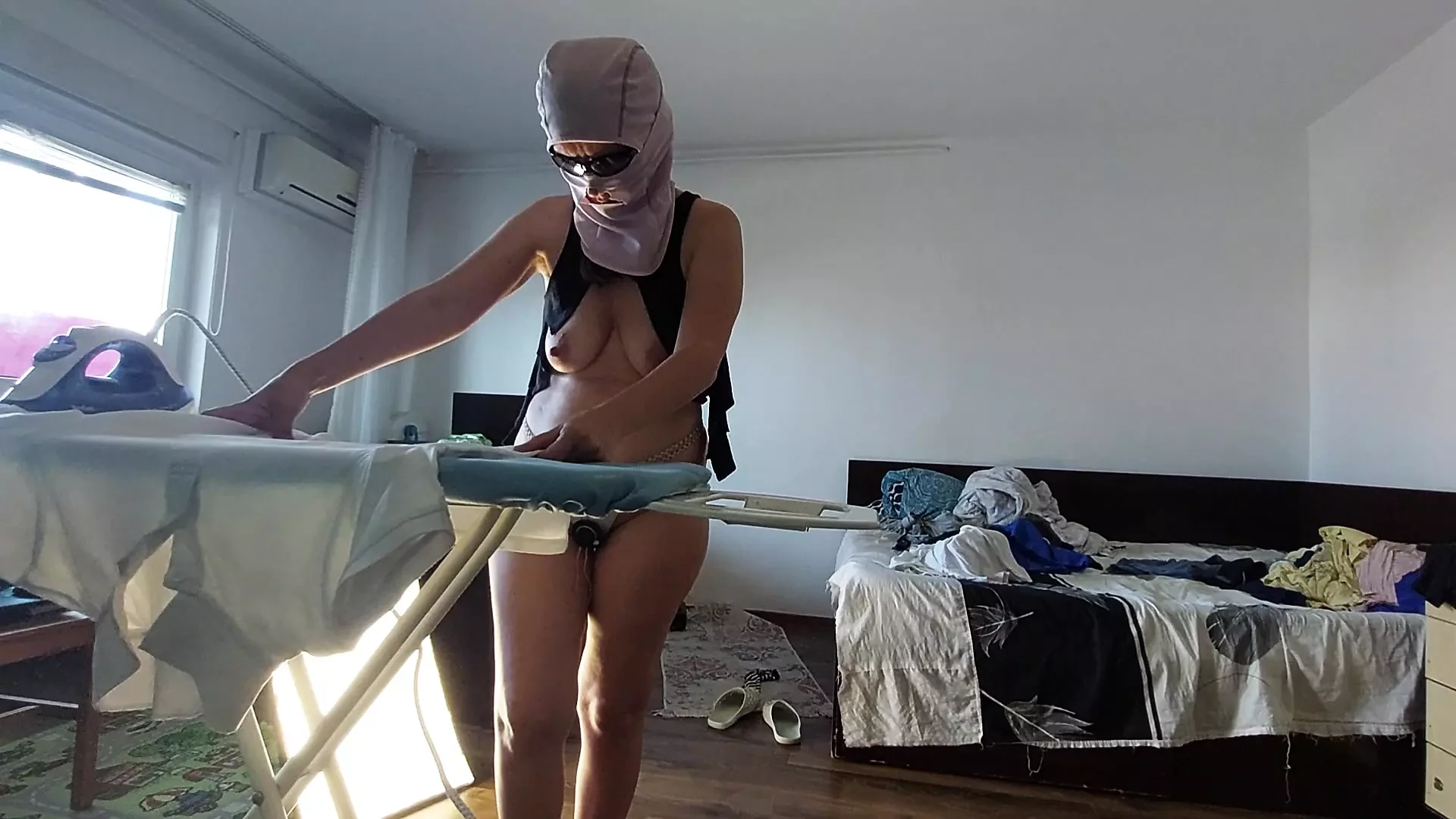 Amateur mom does chores in the naked house.