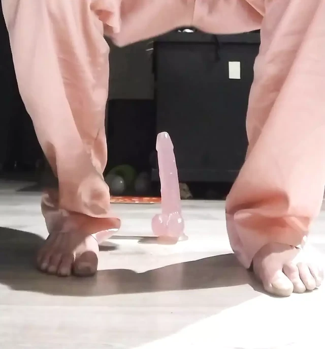 Riding in pink pajamas on a pink dildo.