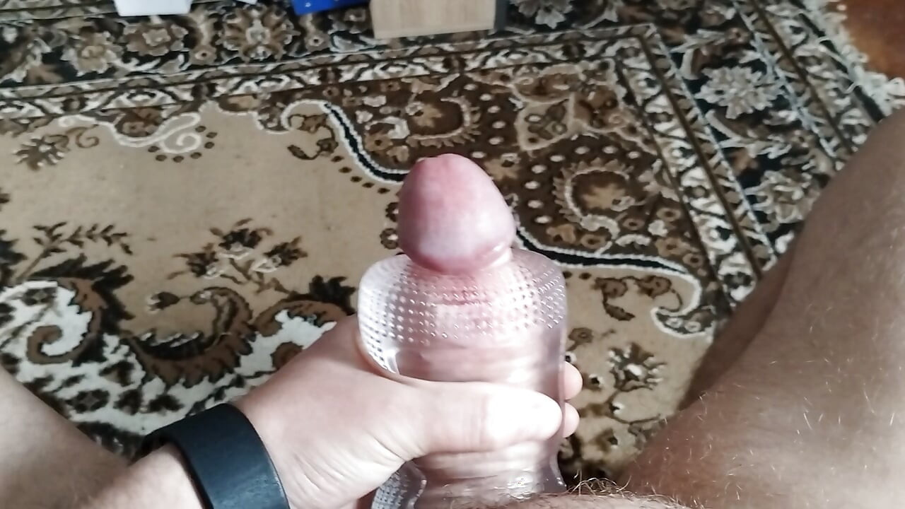 A man masturbates with a sex toy until he cums