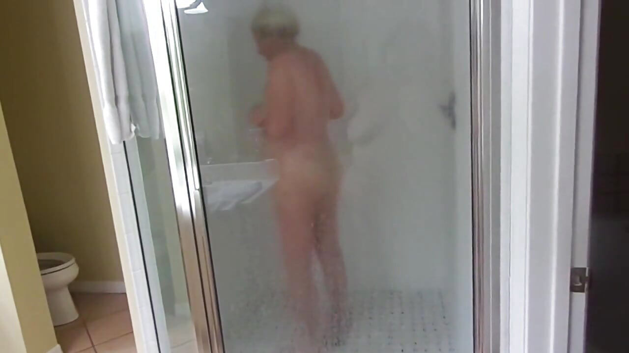 Sexy mature blonde granny takes a shower as we stepdaughter films
