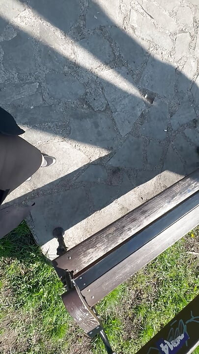 Sexy hot stepmom is horny and caresses herself on a park bench