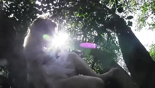 She climbs on tree and fingers her pussy