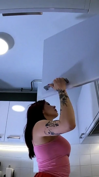 Spectacular moment from "Hottest redhead tattooed cheerleader with over knee socks shows her see through panties in the kitchen"