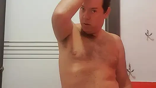 A boy completely naked in a station bathroom