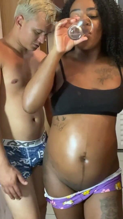 Hot pregnant woman studied in the kitchen while drinking water, but ended up drinking milk in her mouth. | Clip 1