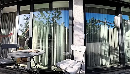 Wonderfully beautiful girl in a summer dress no panties on the balcony shows her tight shaved pussy to the neighbors