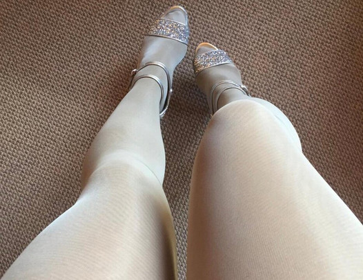 Leg tease in layerd shiny white crystal pantyhose and bright high heels.