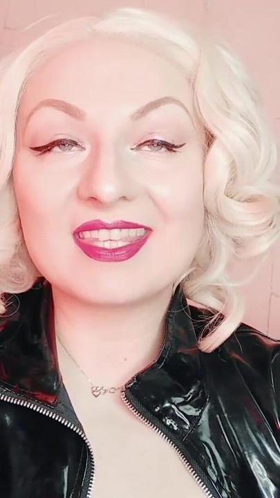 Key moment from "rude FemDom JOI jerk off instructions in PVC coat - fetish porn - Mistress Arya Grander"
