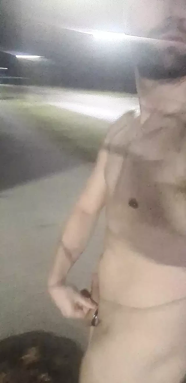 Sexy hunky jock walks around a plaza naked outside in public