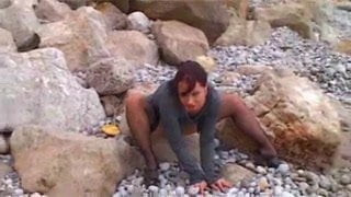Olga smokes and strips on the rocks  FM14