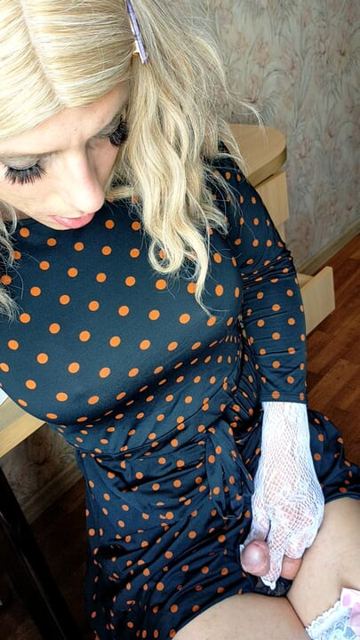 Shemale twists her ass in front of the window, seducing random passers-by and walks in the entrance dressed in women's clothes