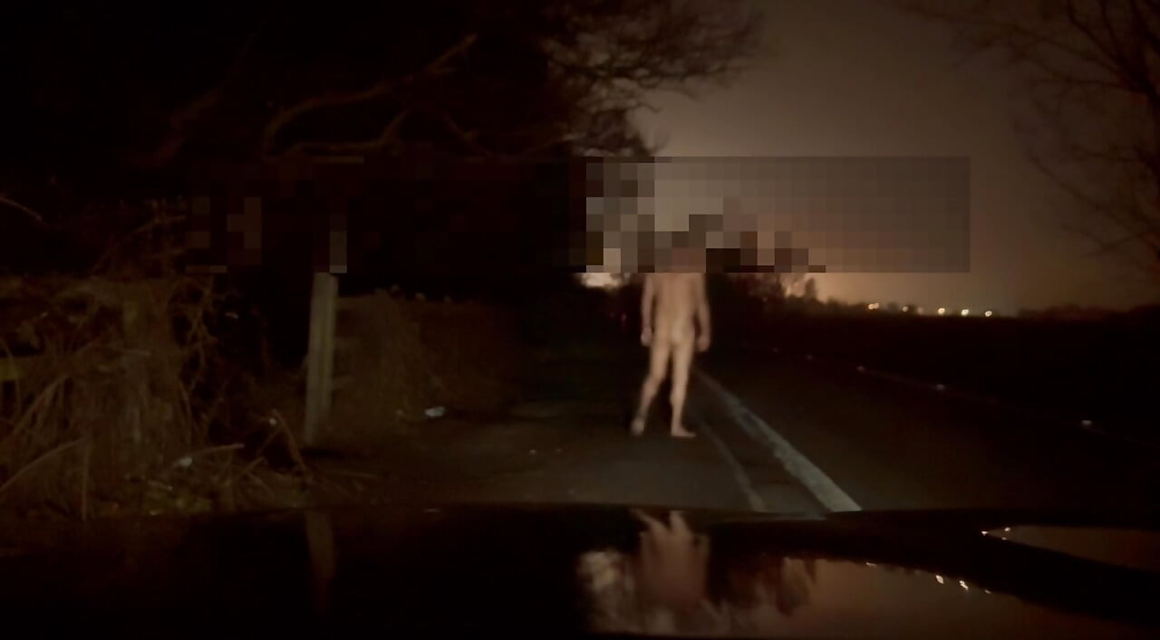 Crazy naked exhibition barefoot with cars passing close