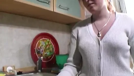 A wild German chick gets her small tits covered with cum in the kitchen