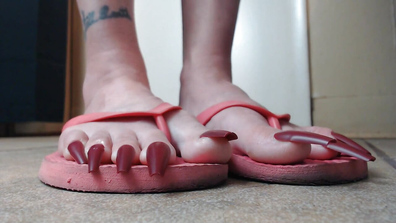 Long red toenails pink flipflops