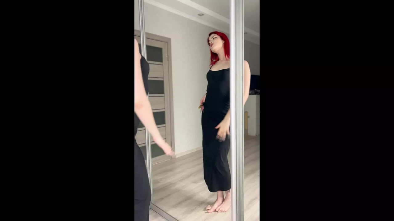 Dance sexy redhead in long black tight dress