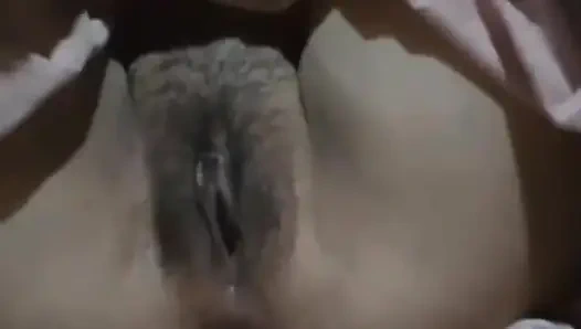 Alone in the house, a woman is calming her pussy with eggplant