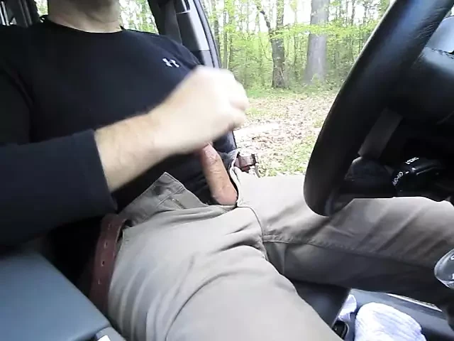 Horny so I pull the car over and jerk-off in a parking lot. I cum, get out and pull up my pants