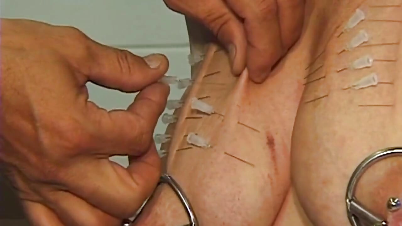 Mature Redhead MILF Endures Needles and Heavy Weights