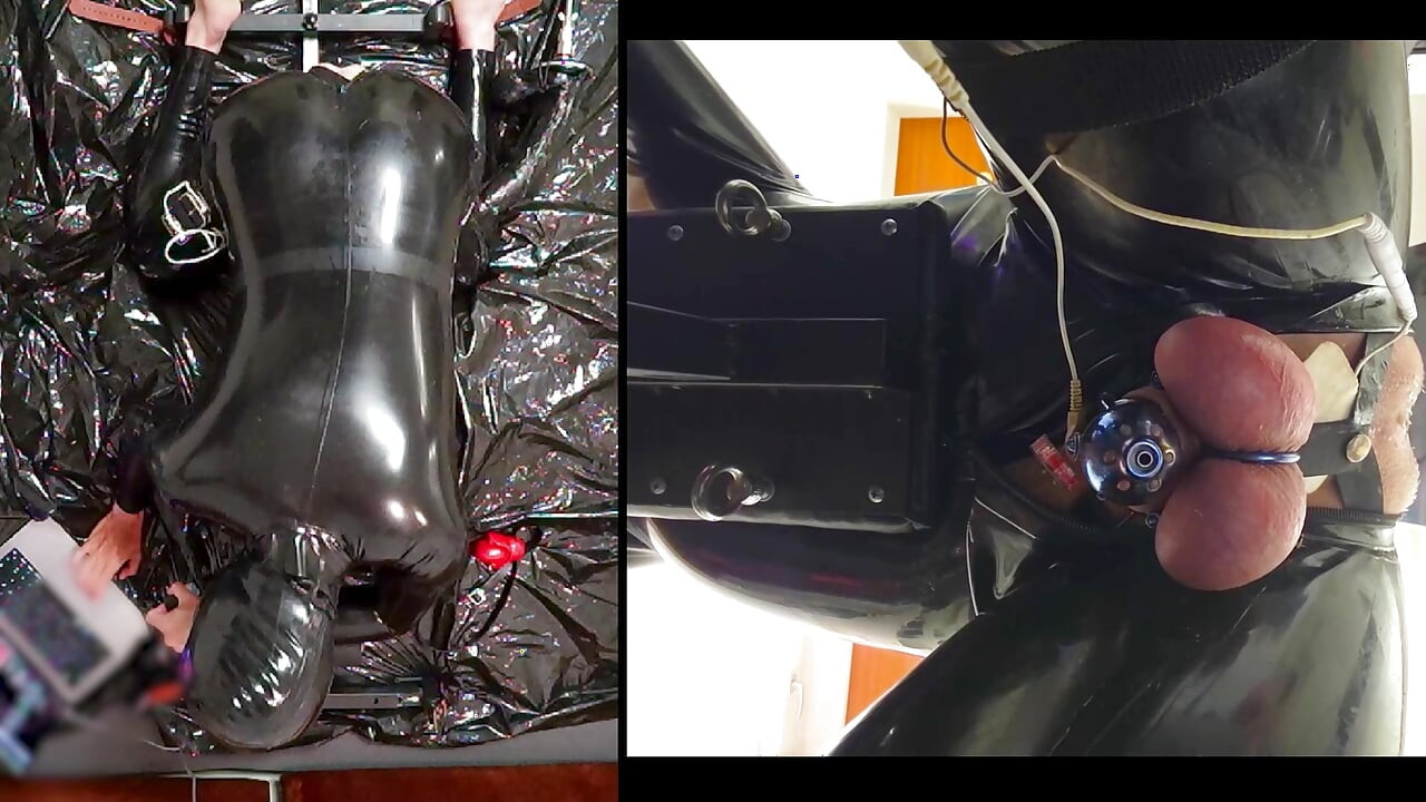 Session in the pillory with Latex Catsuit, PA Chastity, Giant Didildo and Estim