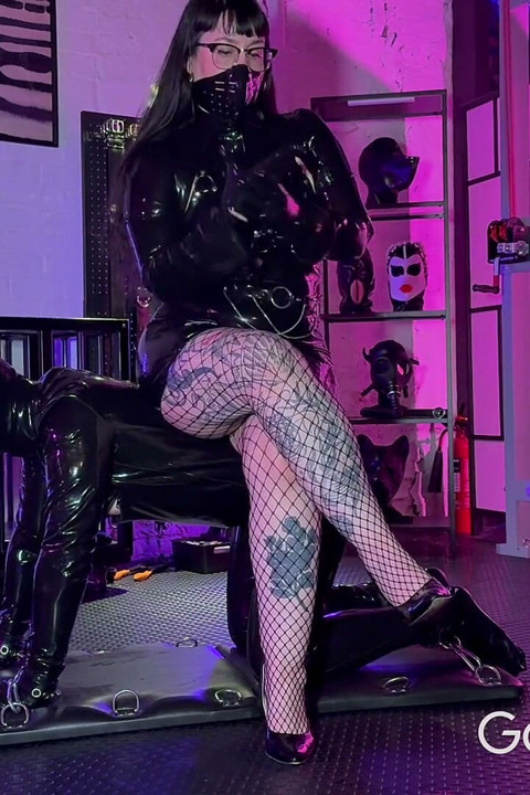 Latex Gimp Trained to Suck Dildo While Being Spanked