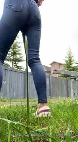 Tattooed Beauty takes a tinkle in the garden